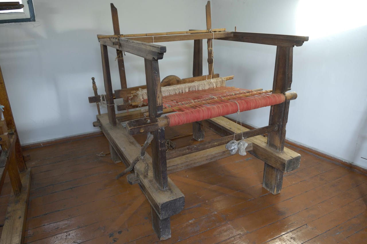 18th-century wooden floor loom with two harnesses from Crete showing the heddle frames warp beam and frame structure used in traditional Greek weaving