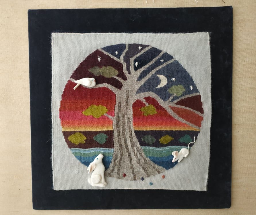 Weft-faced tapestry weaving on a frame loom, showing an abstract tree pattern built entirely from colored weft
