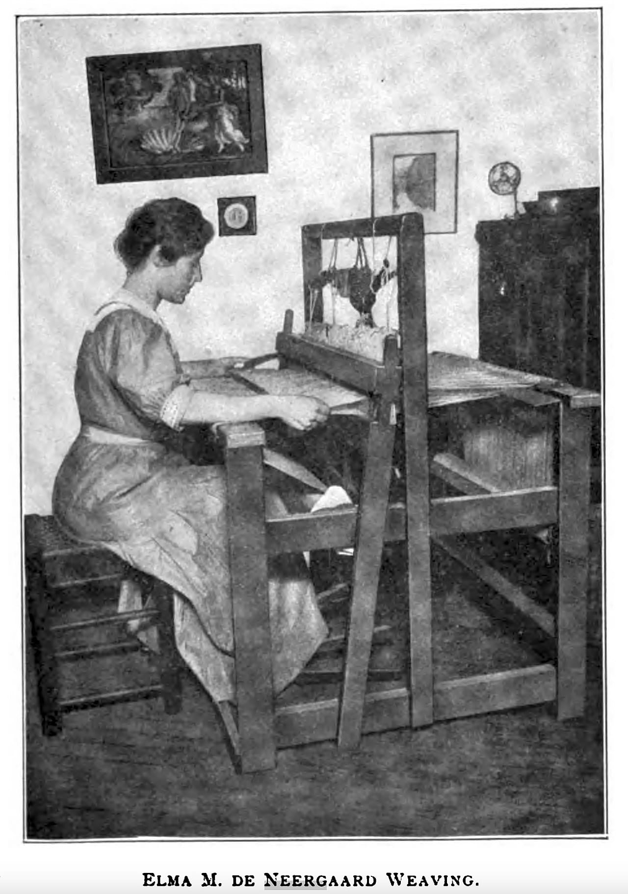 Historical photograph of a woman weaving at a loom, the cloth building on the breast beam as she works the heddle and beater
